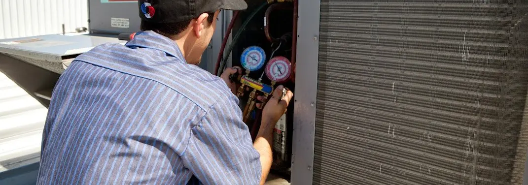 HVAC technician servicing a condenser unit in Chatham