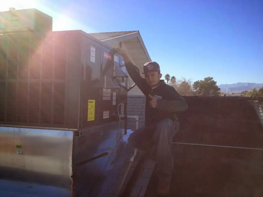 HVAC technician performing HVAC Inspection on a rooftop unit in Chatham